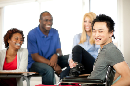 Photo of a man in a chair and others