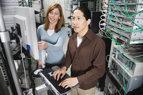 photo of two people working